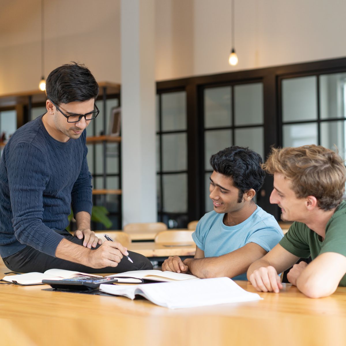 serious-teacher-checking-assignment-two-students